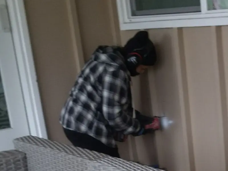 Professional electrician installing an exterior outlet in Plumsted